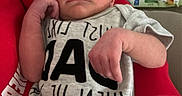 Bryce joined the competition — help win amazing prizes! newborn, baby, infant, onesie, sleeping, hand, arm, bottle, baby_wipes, sofa, blanket, red_clothing, closeup, indoor, care, resting, cute, peaceful, person, portrait