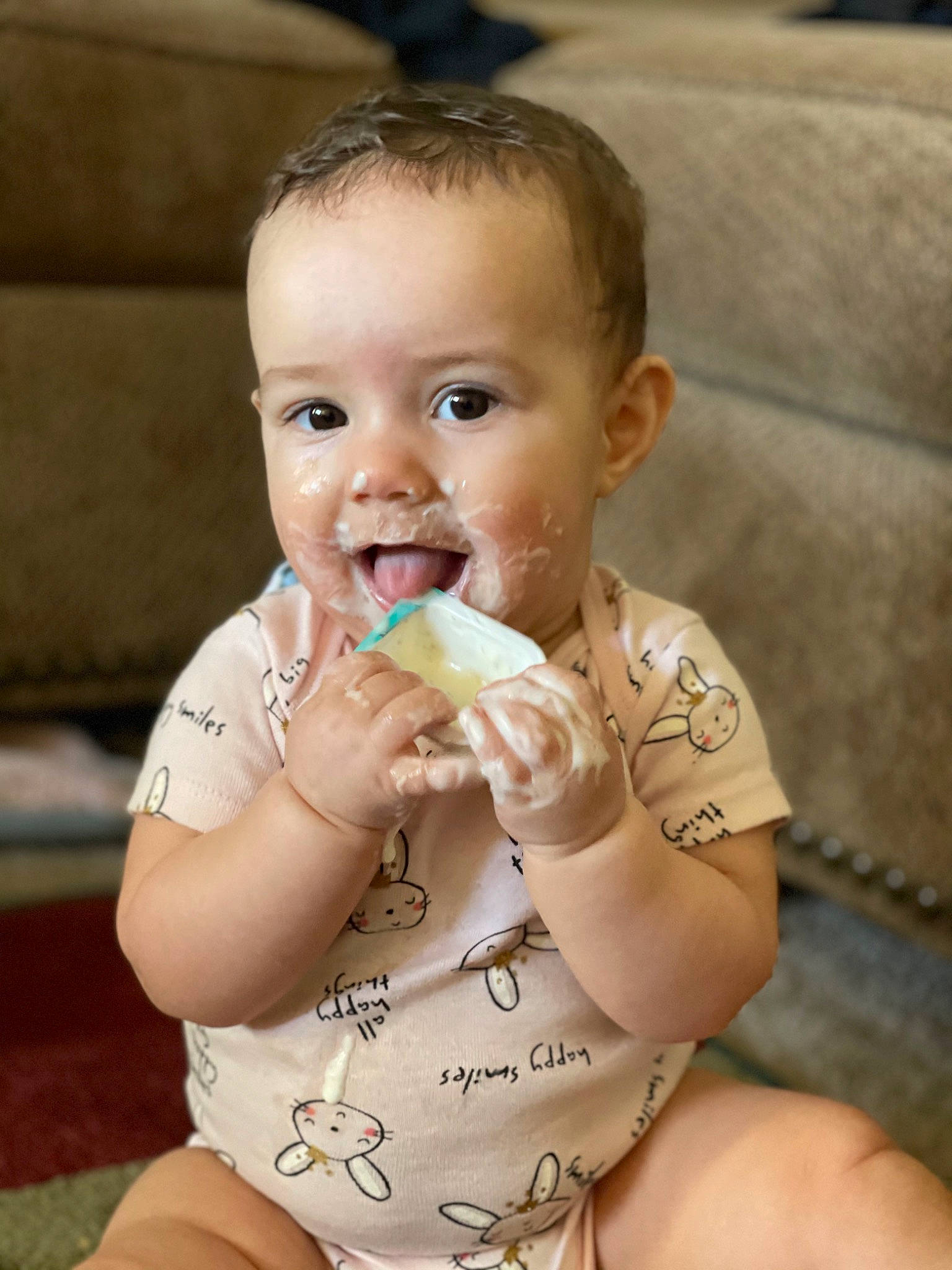 Seattle is registered to the contest to win money with this photo: arm, baby, cheek, drinkware, eye, face, finger, gesture, hair, hand, happy, head, human_body, lip, mouth, neck, nose, person, skin, thumb