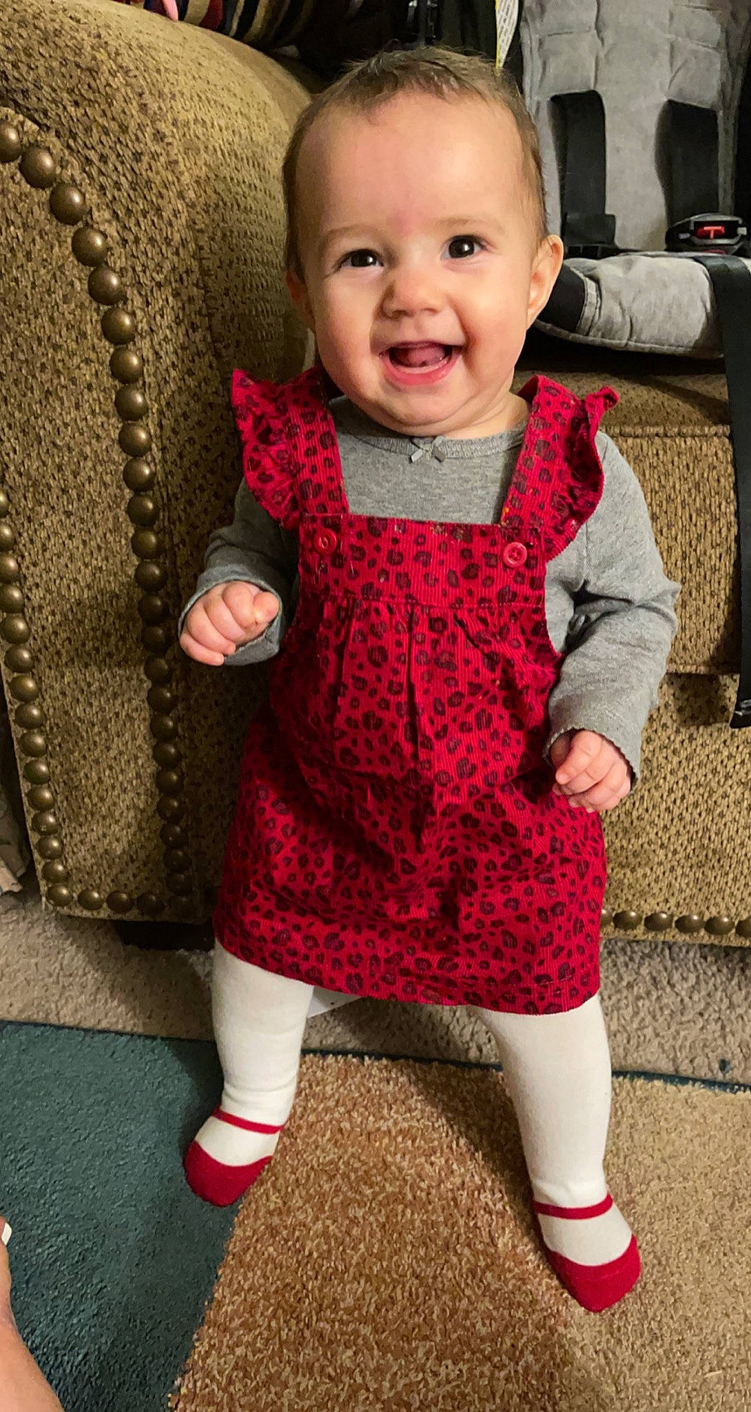 Seattle is registered to the contest to win money with this photo: baby, baby_toddler_clothing, black, clothing, dress, face, facial_expression, finger, human_body, joint, outerwear, person, pink, product, skin, sleeve, smile, standing, textile, toddler