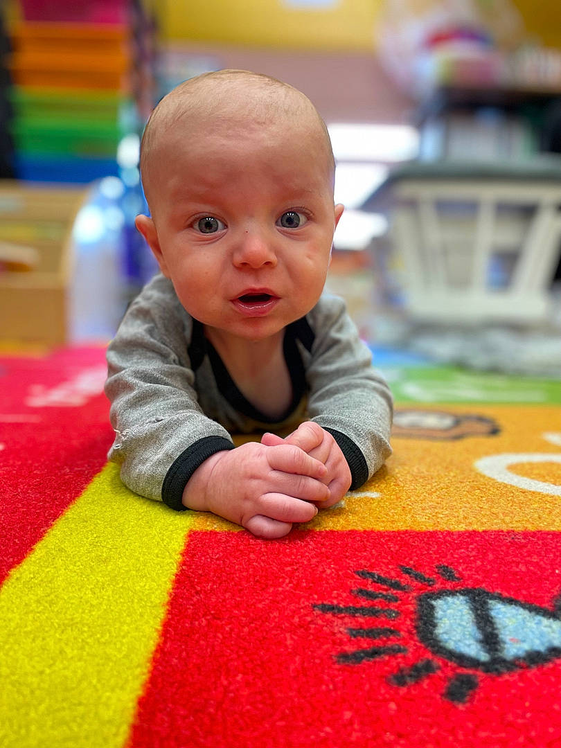 Kevin joined the competition — help win amazing prizes! baby, baby_toddler_clothing, carmine, carpet, cheek, child, crawling, floor, flooring, fun, leisure, linens, pattern, person, play, product, room, sitting, toddler, tummy_time