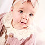 baby, bow, button, cardigan, child, closeup, clothing, curious, cute, expression, face, headband, indoors, infant, knitted, pink, portrait, skin, soft_lighting, young
