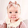 baby, bow, child, closeup, clothing, collar, cute, eyes, face, headband, infant, innocent, pastel, pink, portrait, sitting, smile, soft, studio, young
