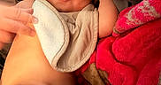 Brian joined the competition — help win amazing prizes! arm, baby, bib, blanket, child, closeup, comfort, cozy, cute, face, gray_blanket, hand, happy, indoor, infant, lying_down, person, red_blanket, skin, smile