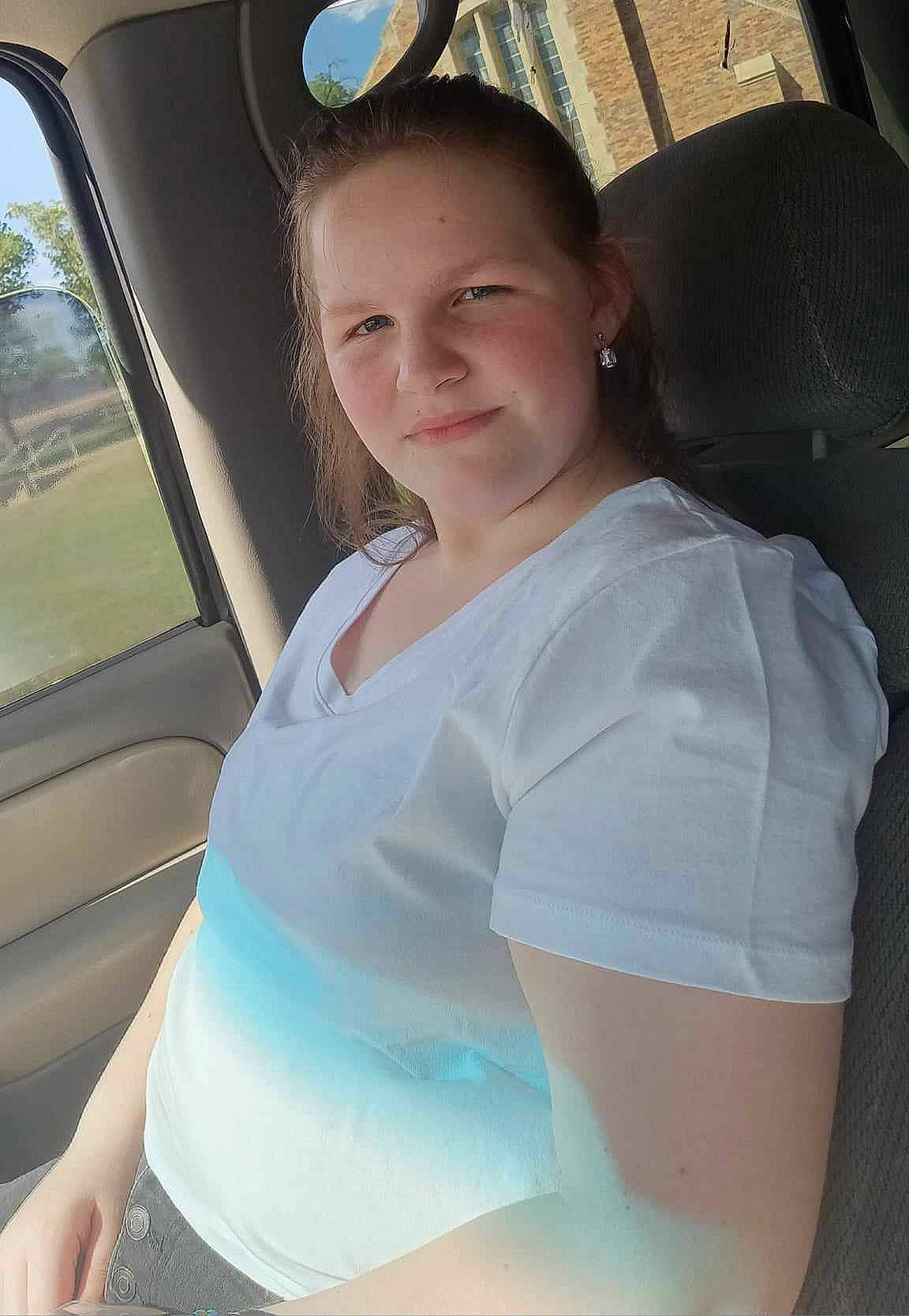 Hannah is registered to the contest to win money with this photo: abdomen, auto_part, automotive_design, automotive_exterior, baseball_cap, car, car_seat, car_seat_cover, chest, elbow, human_leg, joy, leisure, motor_vehicle, person, shoulder, steering_wheel, t_shirt, thigh, trunk