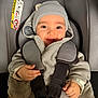 Nolan participe au concours pour gagner de l'argent avec cette photo : baby, baby_clothes, car_seat, child, closeup, clothing, comfort, cute, happy, hat, indoors, infant, person, portrait, safety_harness, seat, seat_belt, smile, warm, young_child