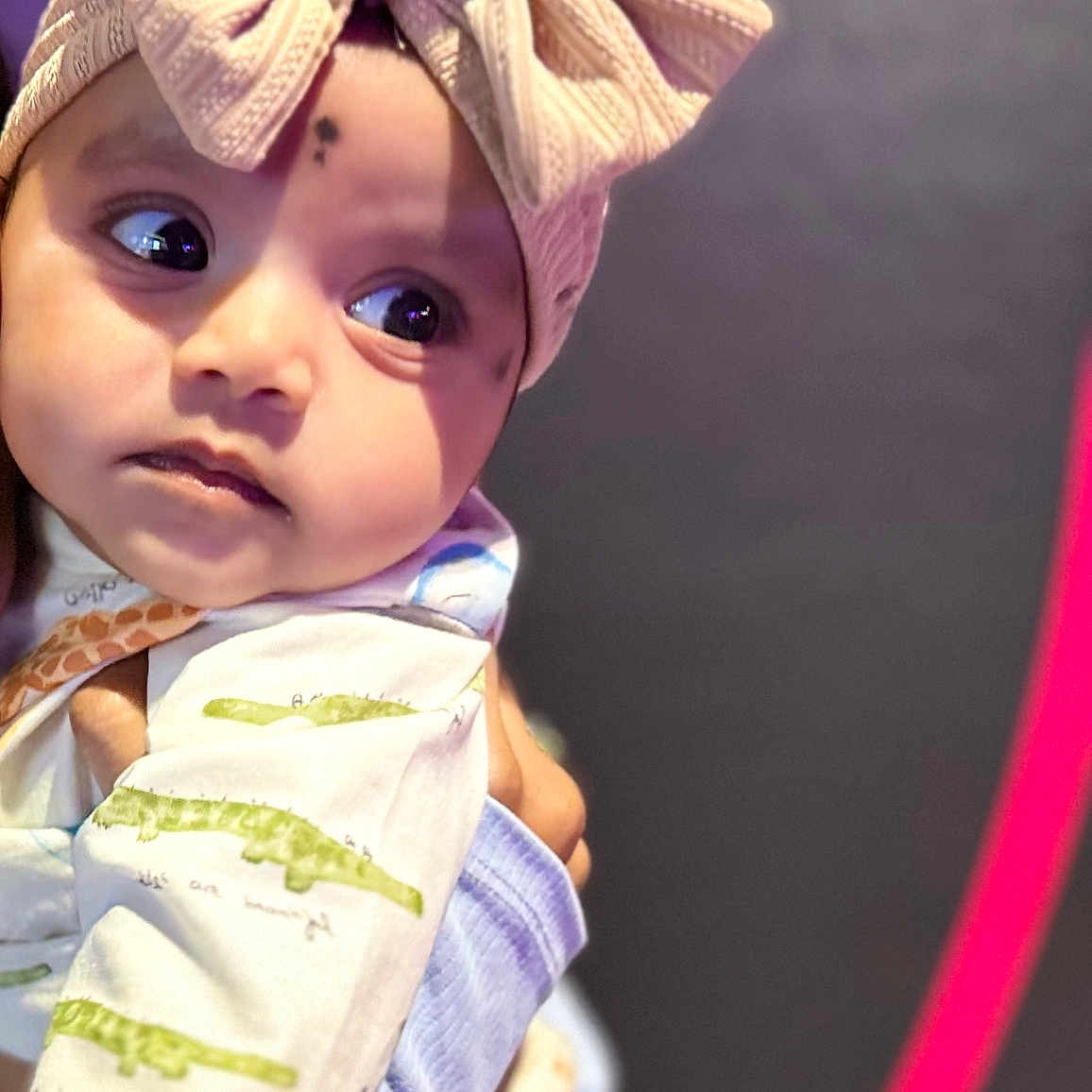 Gowshika joined the competition — help win amazing prizes! baby, bow, child, closeup, clothing, curious, cute, expression, eyes, face, gaze, hand, headband, indoors, infant, knitted, pastel, patterned, portrait, soft
