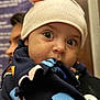 Adele is registered to the contest to win money with this photo: baby, child, hat, pink, ears, blanket, colorful, patterned, face, eyes, closeup, portrait, person, adult, background, blur, warm, indoor, clothing, cute