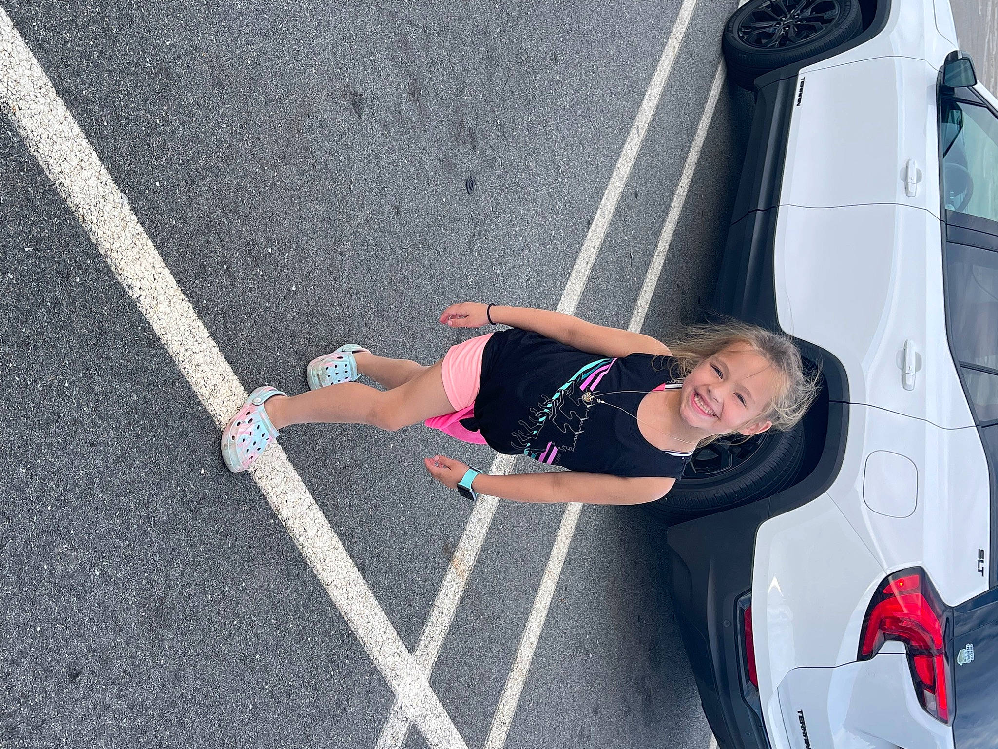 Kenna is registered to the contest to win money with this photo: asphalt, automotive_design, automotive_exterior, automotive_lighting, automotive_tire, bumper, car, electric_blue, hood, joy, motor_vehicle, person, recreation, rim, road, road_surface, shorts, sidewalk, tire, vehicle