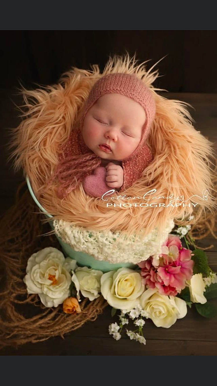 Alaiyah is registered to the contest to win money with this photo: baby, child, child_model, flower, hair_accessory, headwear, person, pink, plant, toddler