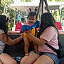 Amelia is registered to the contest to win money with this photo: baby, bench, bunny_ears, child, clothing, daylight, girl, hair, outdoor, people, person, phone, pigtails, pink_shirt, shorts, shuttle, smile, tram, trees, water_bottle