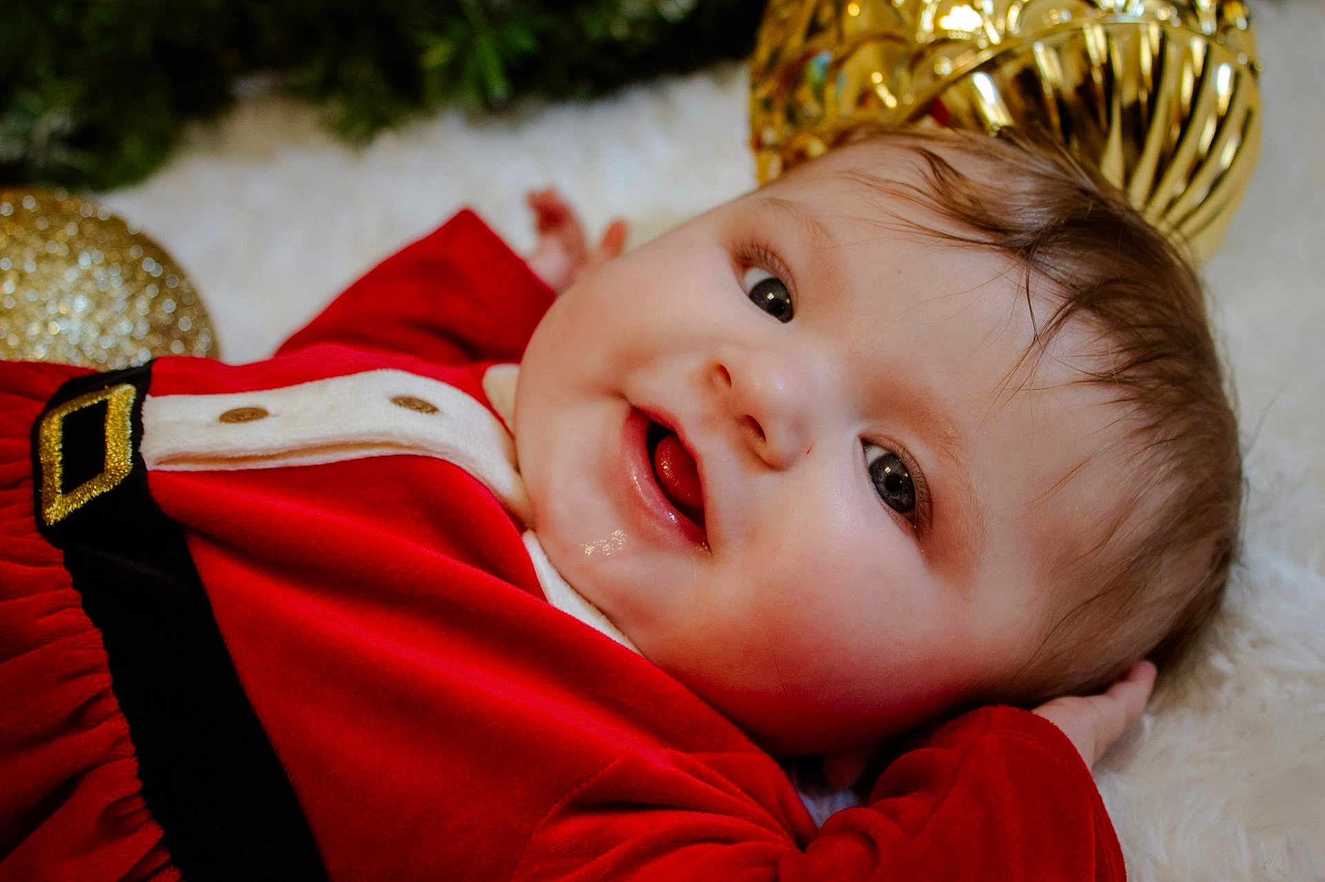 Nova joined the competition — help win amazing prizes! baby, infant, smiling, red_dress, christmas, holiday, festive, gold_ornaments, soft_surface, happy, face, portrait, closeup, person, child, cute, holiday_decor, christmas_theme, cozy, celebration