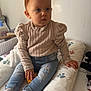 Jöy participe au concours pour gagner de l'argent avec cette photo : baby, child, clothing, cushion, expression, face, furniture, hand, head, indoor, jeans, light, paw_print, person, portrait, sitting, socks, sweater, toddler, wall