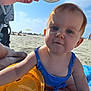 Jöy participe au concours pour gagner de l'argent avec cette photo : baby, child, beach, sand, sunny, blue_sky, swimsuit, toy, hand, wooden_disc, cartoon_lion, towel, play, outdoor, summer, people, stroller, relaxation, vacation, sunlight