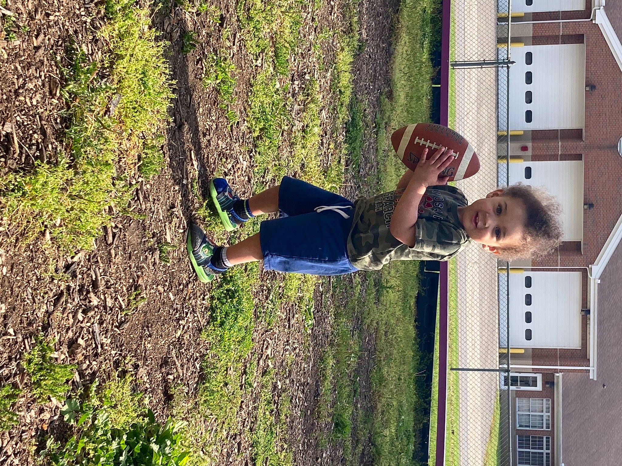 Malachi is registered to the contest to win money with this photo: facade, fun, grass, leisure, people_in_nature, person, plant, recreation, shadow, shorts, shrub, soil, t_shirt, tree, window
