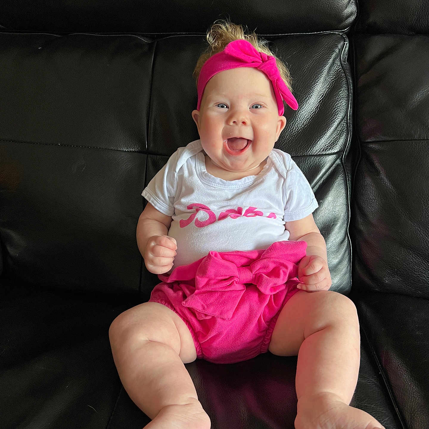 Ellie is registered to the contest to win money with this photo: accessories, baby, babylaughing, chair, clothing, couch, cushion, diaper, face, furniture, happy, head, homedecor, laughing, person, photography, portrait, shorts, sitting, t_shirt