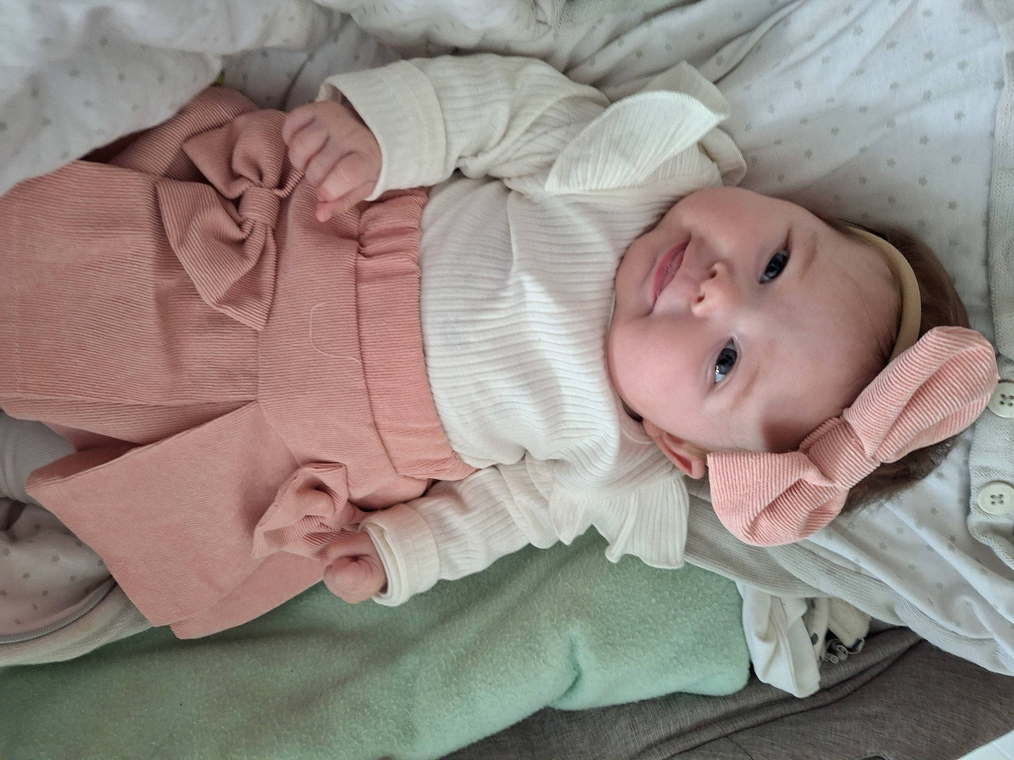 Railey participe au concours pour gagner de l'argent avec cette photo : baby, baby_products, baby_toddler_clothing, cheek, child, comfort, eye, head, headgear, headwear, linens, pattern, person, pink, product, sitting, skin, sleep, sleeve, textile