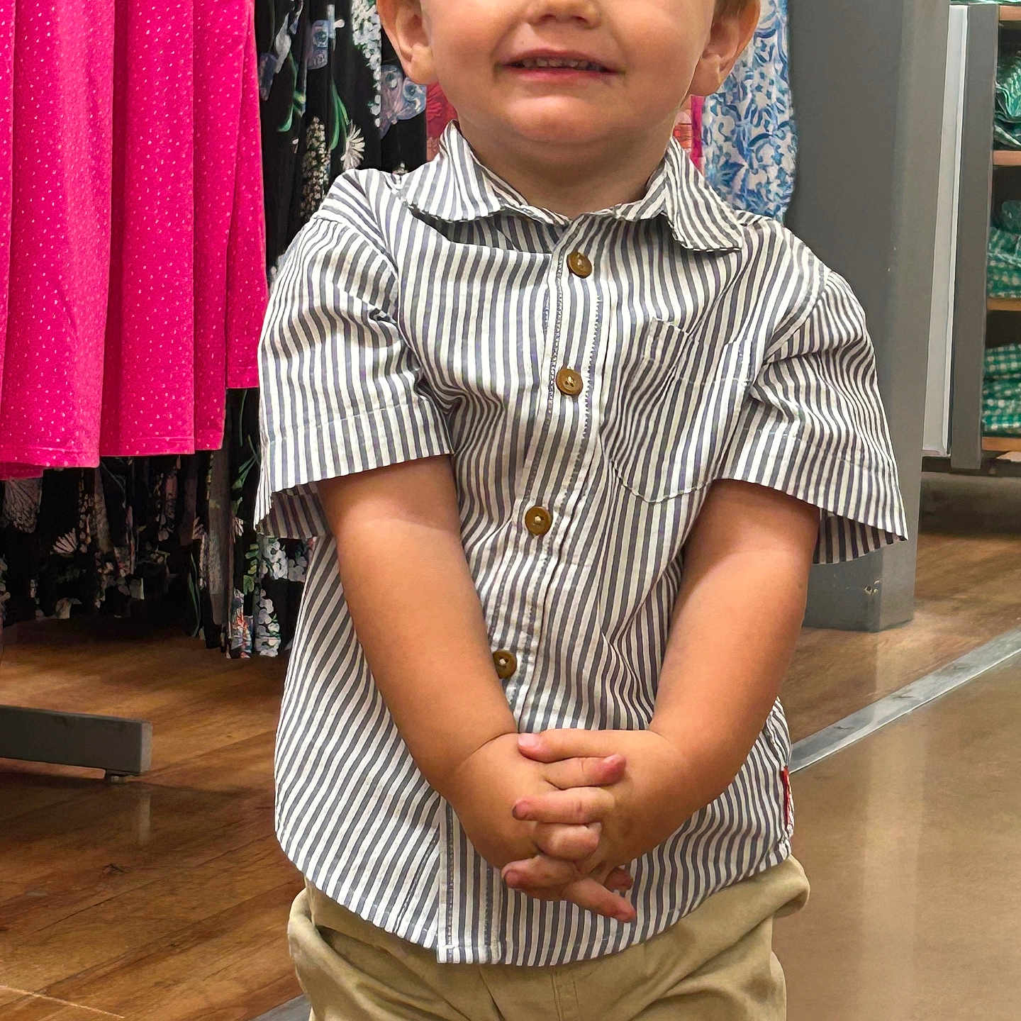 Tannen is registered to the contest to win money with this photo: beige_pants, boy, casual_wear, child, clothing_store, colorful_clothes, cute, hands_clasped, happy, indoor, portrait, retail, shopping, short_sleeves, smile, standing, store_shelves, striped_shirt, wooden_floor, young