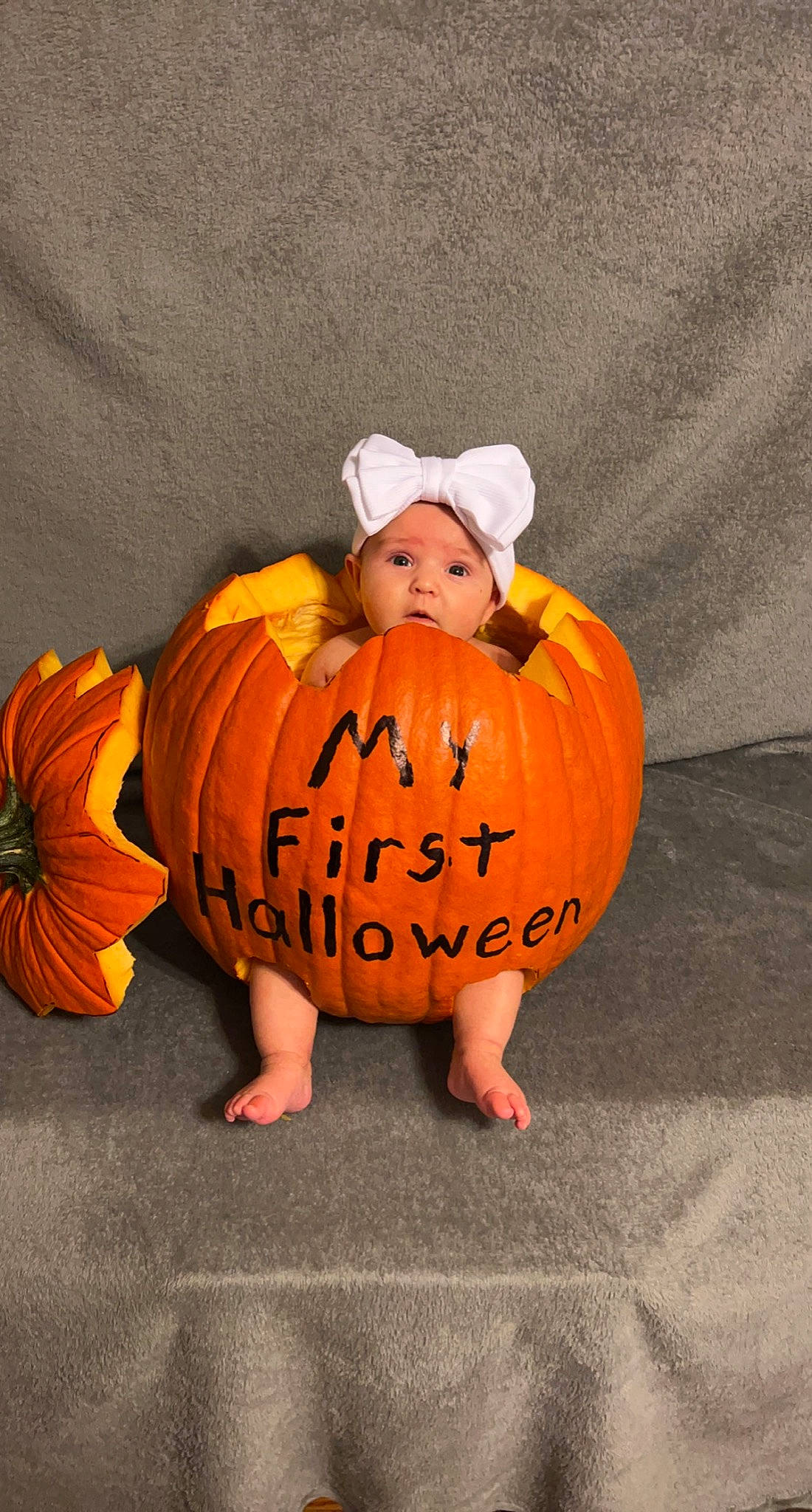 Ava is registered to the contest to win money with this photo: art, baby_toddler_clothing, calabaza, cucurbita, flooring, gourd, hat, headwear, jack_o_lantern, natural_foods, orange, person, plant, produce, pumpkin, squash, surprise, toddler, tree, trick_or_treat