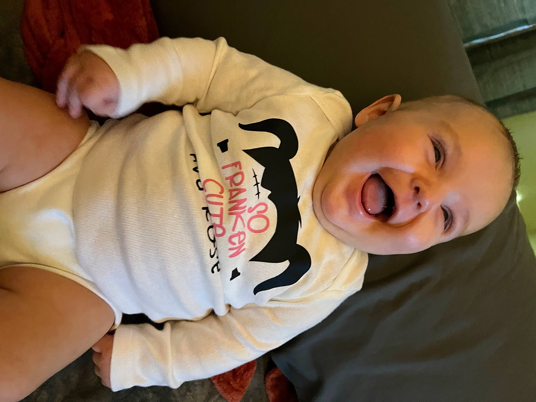 Ava is registered to the contest to win money with this photo: abdomen, baby, baby_toddler_clothing, cheek, chest, child, comfort, elbow, facial_expression, happy, human_body, knee, mouth, neck, person, sleeve, smile, t_shirt, thigh, toddler