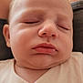 baby, sleeping, close_up, face, infant, peaceful, chubby_cheeks, white_clothing, pacifier_clip, indoor, soft_light, portrait, young_child, relaxed, skin, head, eyes_closed, mouth, person, cozy