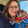 woman, dog, glasses, smile, denim_jacket, bandana, car, oxygen_tube, pet, portrait, close_up, happy, brown_dog, casual_clothing, outdoor_light, seat, window, tree, human, friendship