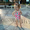 Vianna joined the competition — help win amazing prizes! toddler, child, swimsuit, pool, water, outdoor, sunlight, palm_trees, vacation, lounge_chair, umbrella, person, hair_bow, smile, standing, barefoot, summer, happy, family, resort
