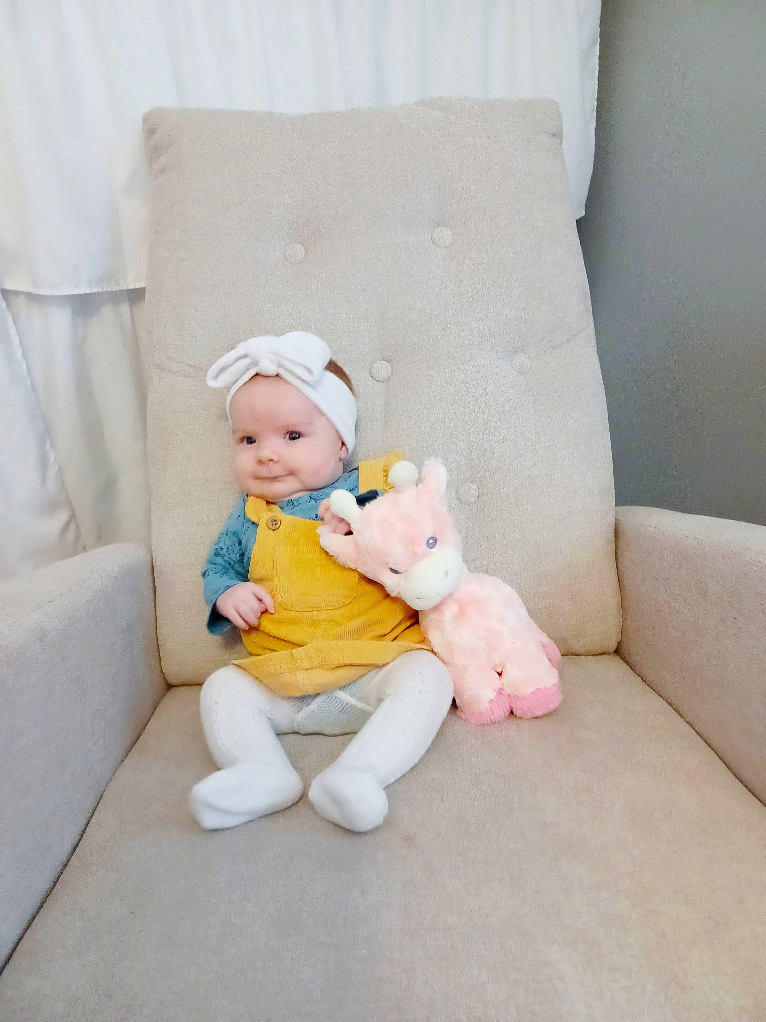 Wren Kennedy is registered to the contest to win money with this photo: baby, baby_toddler_clothing, child, comfort, couch, foot, hat, headwear, human_leg, knee, leg, linens, person, pillow, room, sitting, sleeve, sock, stuffed_toy, thigh