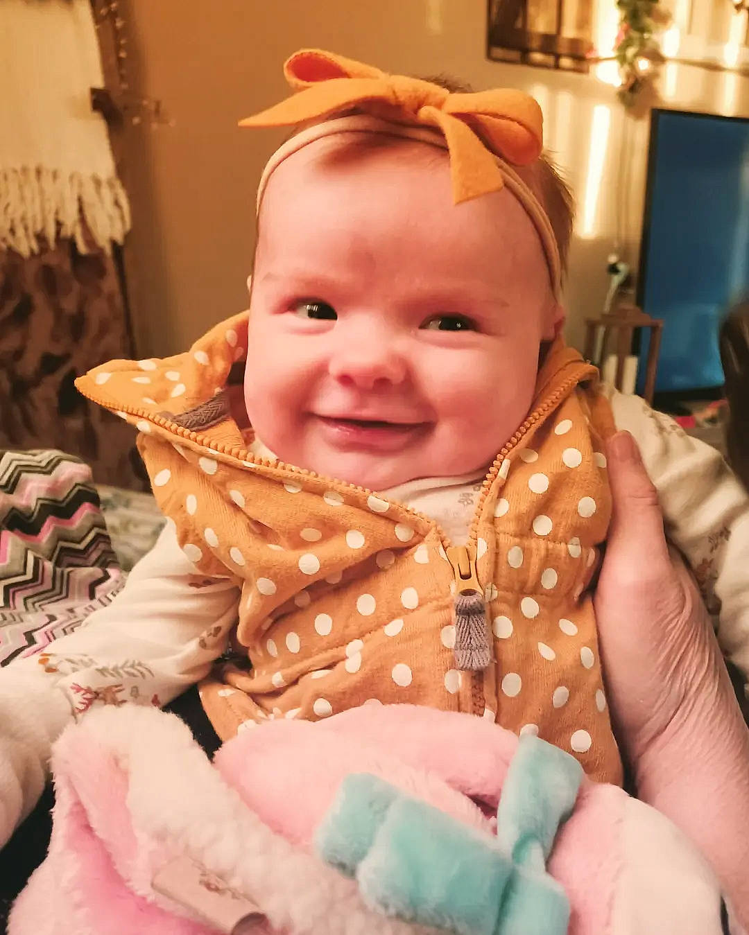 Wren Kennedy is registered to the contest to win money with this photo: baby, baby_products, baby_toddler_clothing, cheek, child, event, eye, fashion_accessory, fun, happy, iris, joy, pattern, peach, person, pink, room, sitting, skin, smile