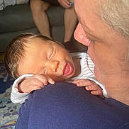 Amari is registered to the contest to win money with this photo: baby, newborn, sleeping, person, adult, shoulder, hand, face, mouth, indoor, couch, rug, clothing, skin, closeup, family, comfort, love, relaxation, portrait