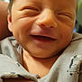 Amari is registered to the contest to win money with this photo: baby, newborn, smiling, close_up, infant, cute, face, child, sleepy, soft, cozy, clothing, zebra_pattern, hand, skin, young, adorable, happy, portrait, person