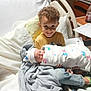 Maverick joined the competition — help win amazing prizes! child, newborn, hospital_bed, blanket, smiling, curly_hair, baby, sibling, hospital_room, medical_equipment, clothing, person, cute, indoors, family, infant, happy, bed, holding, portrait
