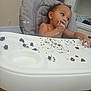 Kayden is registered to the contest to win money with this photo: toddler, high_chair, cake, chocolate, messy, crumbs, frosting, child, indoor, face, hand, food, eating, tray, curious, seat, baby, mouth, person, hair