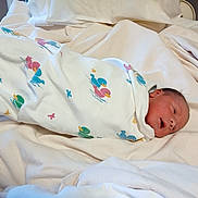 Kayden joined the competition — help win amazing prizes! baby, bed, blanket, child, comfort, cute, duck_pattern, fabric, face, head, hospital, infant, newborn, resting, skin, sleeping, soft, swaddled, white, wrapped