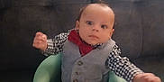 Kayden joined the competition — help win amazing prizes! baby, barefoot, black_pants, bow_tie, checkered_shirt, child, clothing, couch, cute, expression, face, feet, green_baby_seat, hands, indoor, infant, person, seated, vest, young