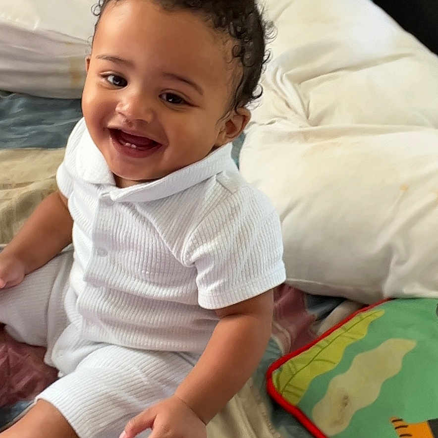 Prince joined the competition — help win amazing prizes! baby, bed, bedroom, blanket, couch, cushion, face, furniture, happy, head, homedecor, indoors, linen, person, photography, pillow, portrait, quilt, room, smile