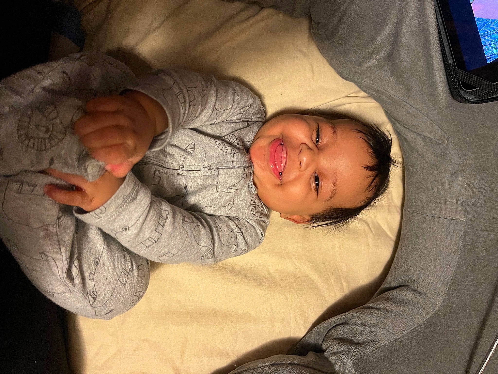 Zakari is registered to the contest to win money with this photo: baby, beauty, child, comfort, couch, elbow, eye, finger, fun, gesture, joy, linens, mammal, mouth, nap, nose, person, room, skin, smile