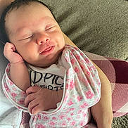 Mylah joined the competition — help win amazing prizes! baby, sleeping, infant, pink, floral_pattern, clothing, hand, person, resting, smile, cute, newborn, cozy, soft, arm, closeup, face, peaceful, indoors, carpet