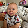 baby, bed, blue_eyes, child, chubby, clothing, cute, face, hands, happy, indoor, infant, mickey_mouse, person, pillow, shirt, sitting, skin, smiling, toy