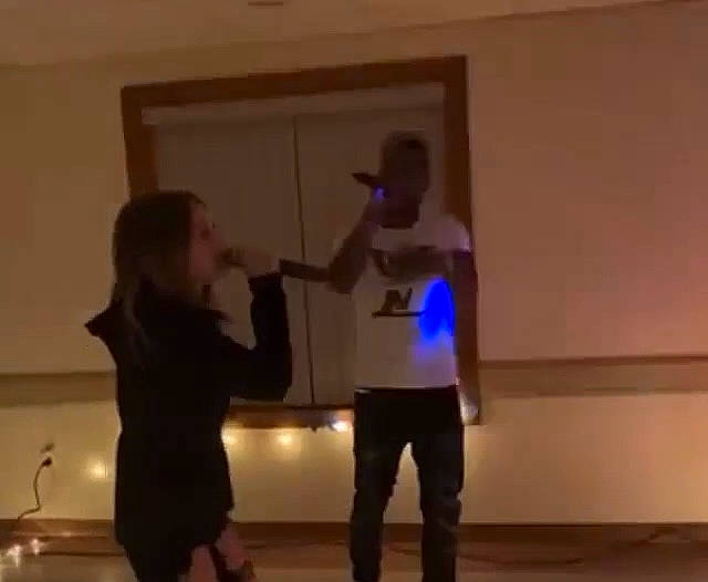 Madison joined the competition — help win amazing prizes! ceiling, conversation, entertainment, event, flooring, fun, gesture, hardwood, performing_arts, person, room, standing, t_shirt, under_exposed, visual_arts, wood