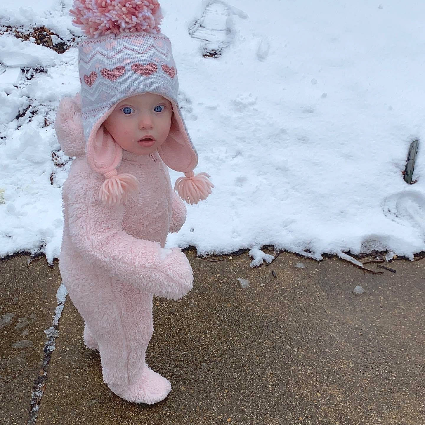 Violette is registered to the contest to win money with this photo: art, baby, bridal_accessory, cap, child, dress, embellishment, face, fashion_accessory, freezing, fur, headgear, headwear, human_body, knit_cap, person, precipitation, snow, toddler, tree