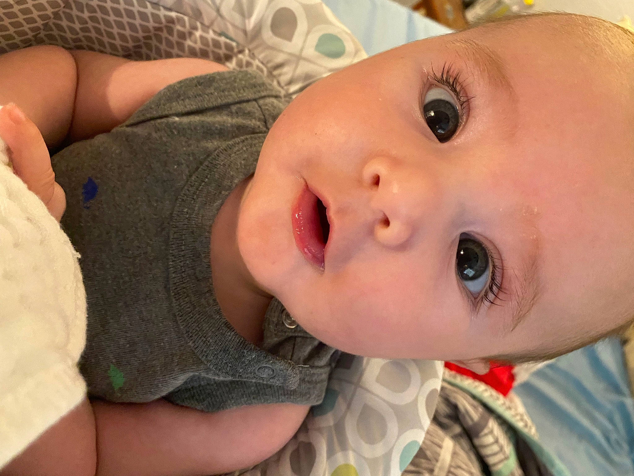 Archibald is registered to the contest to win money with this photo: baby, baby_toddler_clothing, cheek, child, chin, comfort, eyelash, fun, happy, iris, lip, mouth, no_expression, nose, pattern, person, portrait_photography, skin, sleeve, toddler