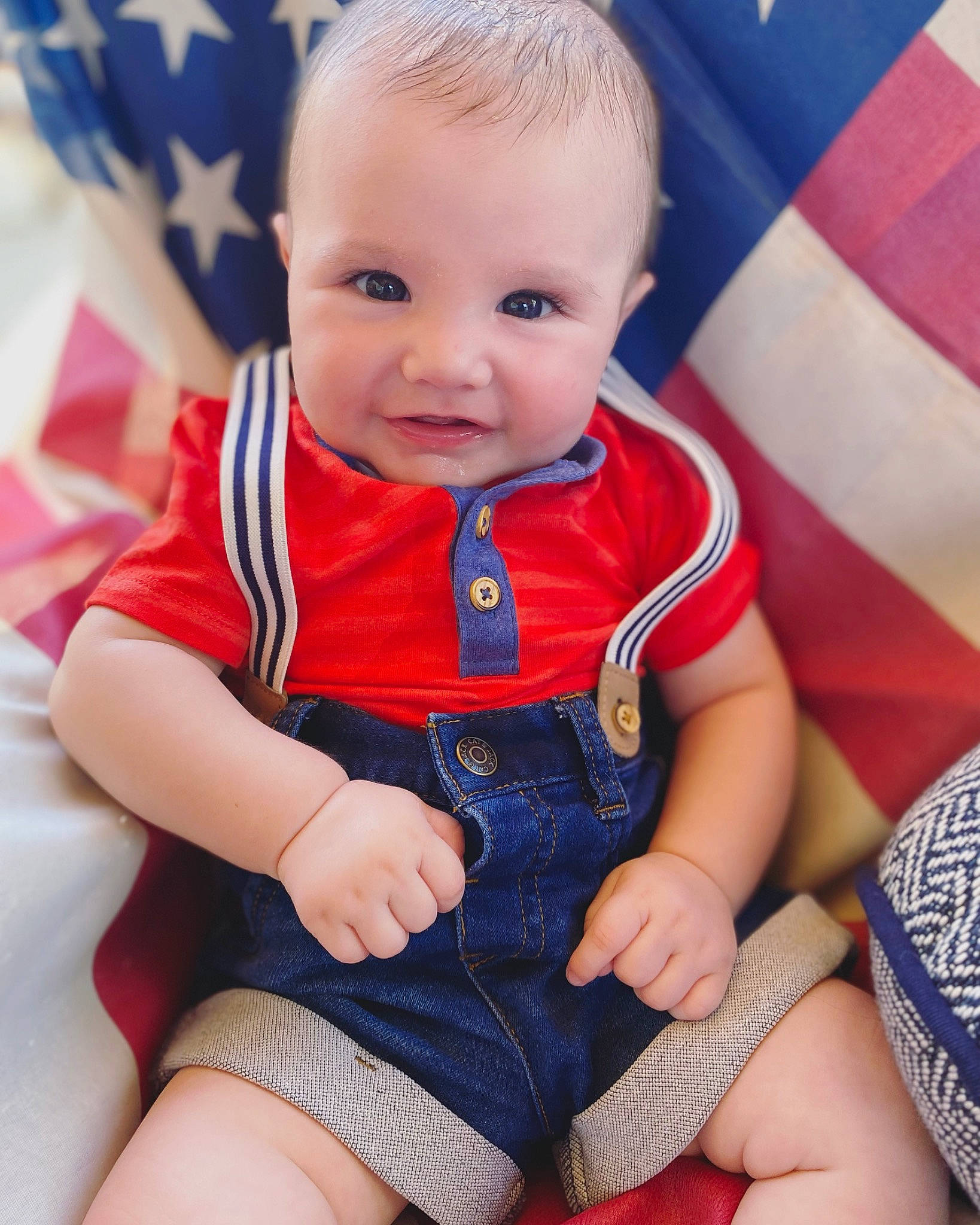 Archibald is registered to the contest to win money with this photo: baby, baby_toddler_clothing, blue, cheek, dress, facial_expression, finger, happy, head, human_body, iris, lip, nose, orange, person, skin, sleeve, smile, textile, thigh