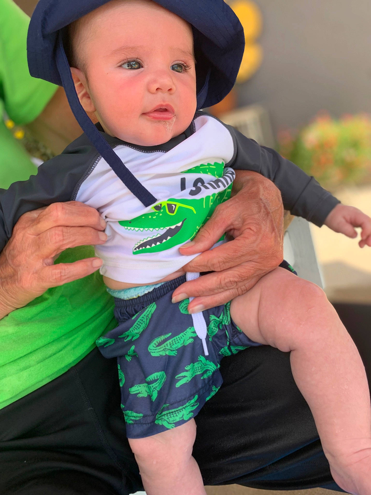 Archibald is registered to the contest to win money with this photo: arm, baby, baby_toddler_clothing, child, eye, face, finger, fun, grass, green, hand, happy, hat, human_leg, person, sitting, skin, sleeve, sun_hat, thigh