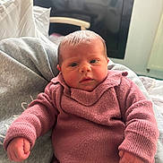 Anelya a rejoint le concours — aidez-le/la à gagner de superbes lots ! baby, newborn, infant, pink_clothing, knitwear, face, hand, blanket, couch, indoor, portrait, cute, small, child, person, cozy, warm, resting, soft, curious