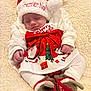 Anelya a rejoint le concours — aidez-le/la à gagner de superbes lots ! baby, sleeping, christmas_hat, christmas_clothing, red_bow, reindeer_slippers, blanket, festive, holiday, cute, infant, white_clothing, soft_texture, smiling, cozy, holiday_season, christmas_tree, gift_box, santa_claus, indoors