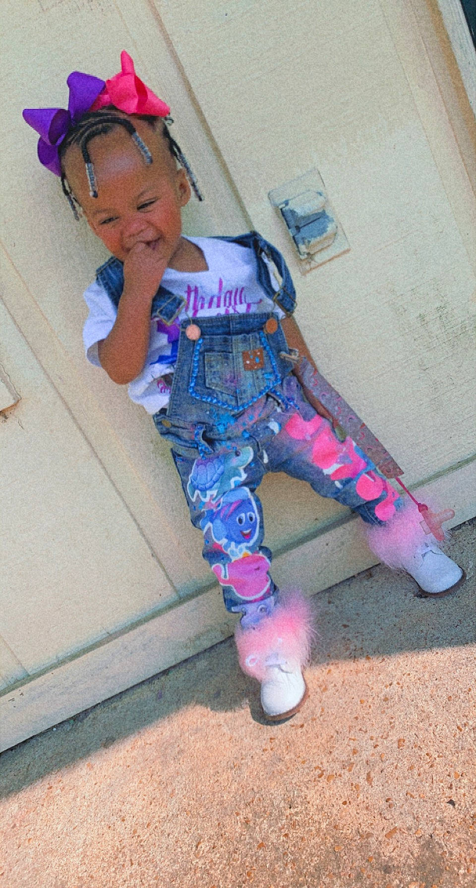 Lay is registered to the contest to win money with this photo: baby_toddler_clothing, cap, carmine, child, costume, electric_blue, eyewear, fun, helmet, human_leg, leg, magenta, person, personal_protective_equipment, pink, purple, shoe, sitting, sleeve, sock