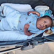 Djawël participe au concours pour gagner de l'argent avec cette photo : baby, infant, stroller, blanket, teddy_bear, clothing, mickey_mouse, socks, cute, child, lying_down, comfort, soft_toys, outdoor, sunlight, person, young, portrait, resting, cozy