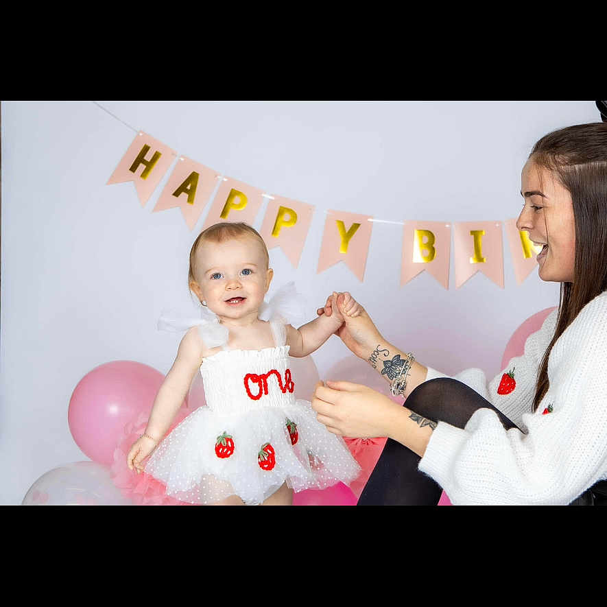 Sophia is registered to the contest to win money with this photo: adult, baby, balloon, bodypart, clothing, dress, face, female, finger, hand, happy, hat, head, people, person, photography, portrait, smile, sphere, woman