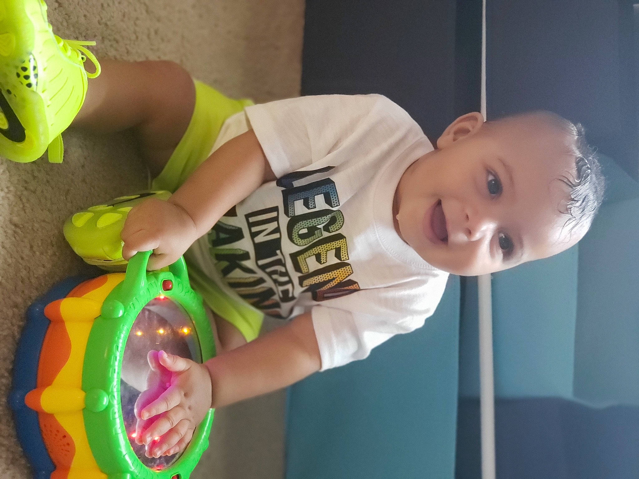 Royce is registered to the contest to win money with this photo: arm, baby, baby_playing_with_toys, baby_products, baby_toddler_clothing, child, finger, flash_photography, foot, fun, grass, hand, happy, human_leg, joy, party_supply, person, smile, sports_toy, t_shirt