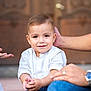 child, toddler, smiling, portrait, outdoor, door, family, parent, hand, white_shirt, sitting, cute, face, eyes, hair, skin, watch, lap, casual_clothing, bonding